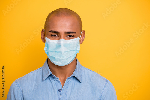 Close up photo of toothy dark skin macho positive good mood wear jeans denim shirt protective flu cold infection facial mask isolated bright yellow background