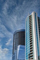 Fototapete - Two Modern Blue Glass and Steel Towers on Blue Sky