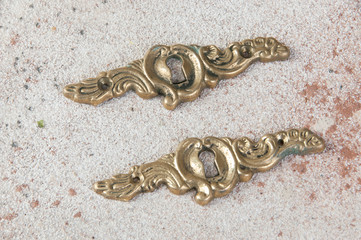 Two antique brass keyholes lock covers