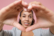 © ViDi Studio - African american business woman in grey suit white shirt isolated on pink background. Achievement career wealth business concept. Mock up copy space. Showing shape heart with hands, heart-shape sign.