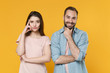© ViDi Studio - Pensive smiling young couple two friends guy girl in pastel blue casual clothes posing isolated on yellow background. People lifestyle concept. Mock up copy space. Put hand on head, prop up on chin.