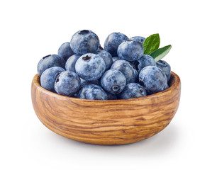 Poster - Beautiful blueberries with blueberry leaves in wooden bowl isolated on white background.