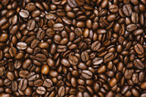 Fototapeta Dinusie - Top view of brown roasted coffee beans, can be use as background, copy space for text.