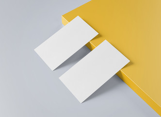 Two white US business card Mockup laying on yellow and grey background 3D rendering