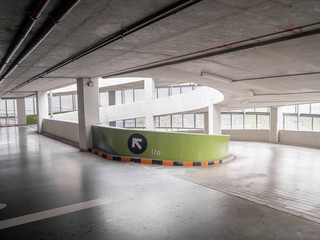 ramp of a parking structure. There is a yellow, black symbol.