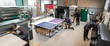 © guruXOX - Large group of worker printmaker technician operator works in digital printing press hall and printshop office with many different type of machine
