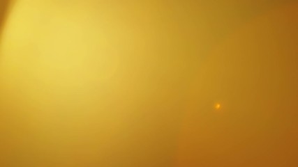 Wall Mural - intense bright warm lens flare on black background. perfect transition for your footage