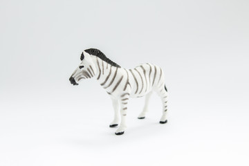 Wall Mural - toy zebra on a white background