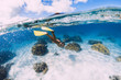 © artifirsov - Woman swimming underwater with yellow fins in ocean. Freediving or snorkeling in Mauritius