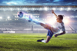 Fototapeta Sport - Soccer player on stadium in action. Mixed media