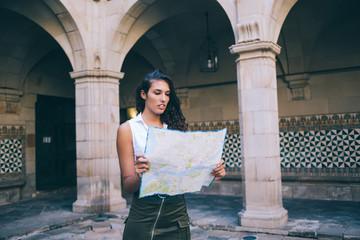 young brunette hipster girl traveler checking location on map having city tour on vacations,beautifu