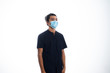 © zahidi - An Asian young man isolated on white background with casual entire and wearing a face mask. Hand gesture stop, sick, respect. during corona virus