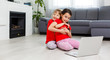 © Angelov - Two little girls are playing with laptop in playroom at home