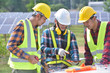 © saravut - Group of engineers meeting on building roof solar. engineer and electrician checking and resolve problem of generate power in solar power plant.