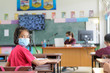 © saravut - school kids with protection face mask against flu virus at lesson in classroom