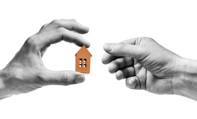 Man's hand reach out to paper house in the palm of woman hand. Concept of rent, search, purchase real estate. Black and white. Isolated on white.