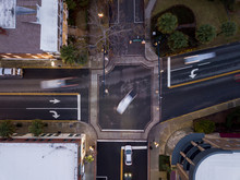 View From Above Of Traffic Intersection With Motion Blur Cars Turning.