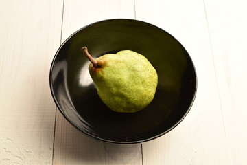 Juicy ripe, sweet, organic green pears, close-up, on a painted wooden table.