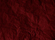 Crumpled dark red paper texture background