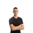 © aigarsr - Casual young man looking at camera with arms crossed on white background