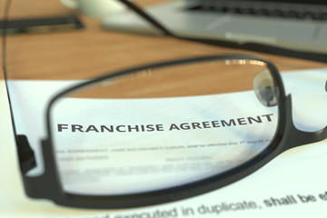 Copy of a franchise agreement behind glasses on a desk, 3D rendering