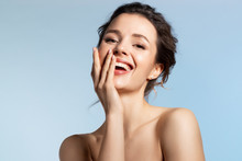 Beautiful Model Covering Joyfully Smiling Open Mouth With Hand. Positive Playful Mood