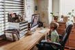 © Cavan Images - Side view of young student learning from teacher by remote education