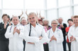 © ASDF - Group doctors and patients clapping their hands to celebrate recovery