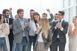 © ASDF - corporate group of employees applauding a young colleague