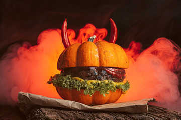 Wall Mural - Burger Halloween. halloween concept of a burger with big beef patties with pumpkin head rolls for the holiday halloween