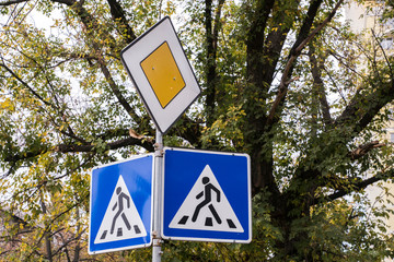 traffic signs pedestrian crossing and main road