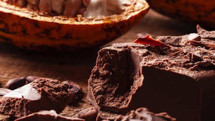 Wall Mural - Fruit cocoa with chocolate pieces on a wooden table