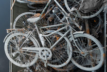 Skip With Heap Of Rusty Muddy Bicycles Retrieved From A River