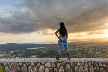 A Young Active African-American Woman Looks Out At The Journey She Completed From The Top Of A Hill With Her Hand On Her Hip One Warm Spring Afternoon At Sunset