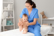 © Pixel-Shot - Massage therapist working with cute baby in medical center