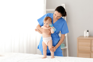 Sticker - Massage therapist working with cute baby in medical center