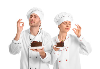 Sticker - Young confectioners with tasty desserts on white background