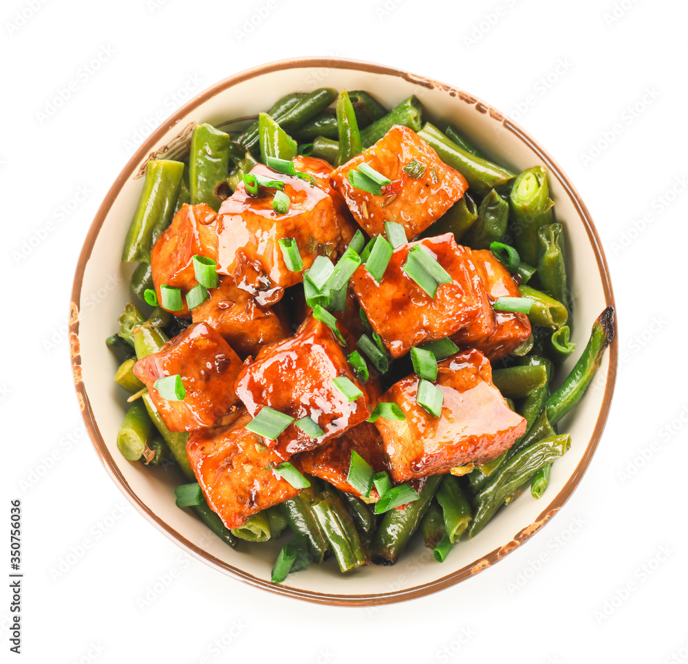 Bowl with tasty tofu cheese and vegetables on white background