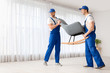 © Pixel-Shot - Loaders carrying furniture in flat