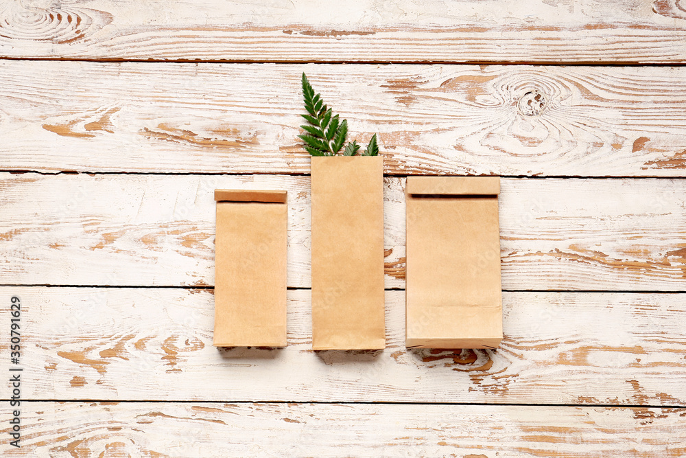 Paper bags on white wooden background