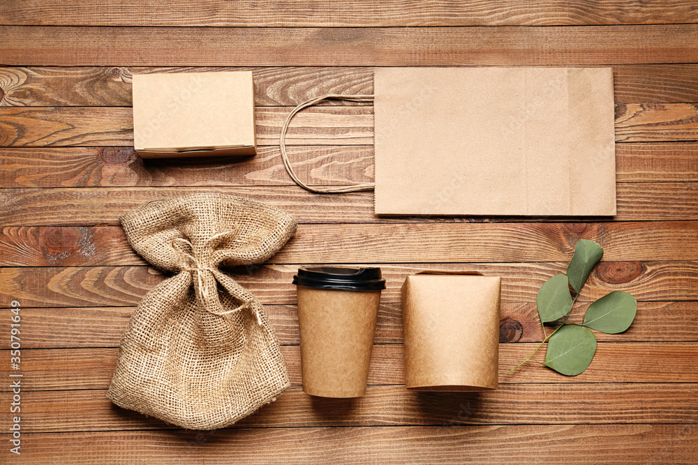 Eco containers for food and drinks on wooden background