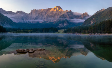 Wall Mural - Spectacular, beautiful sunrise over the alpine Lake Laghi di Fusine in the Julian Alps in Italy