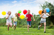 © JackF - children running with air balloons in park .