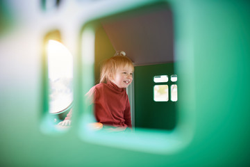 Happy 2 year old toddler playing at the playground