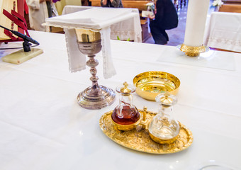 Wall Mural - chalice for wine, blood of christ, and ciborium with host, body of christ, and ampoules with wine and water for consecration