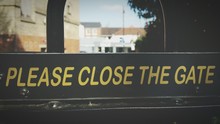 Close-up Of Please Close Gate Sign