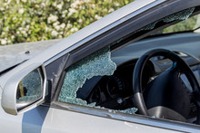 Criminal Incident. Hacking A Car. Broken Driver's Side Window Of Car. Thieves Smashed Window Of Car With Fragments Inside, Glass Was Scattered Throughout. Crime - Broken Window And Theft Belongings