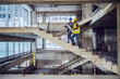 © Dusan Petkovic - Construction worker and main architect climbing the stairs and talking about progress in construction of new building.