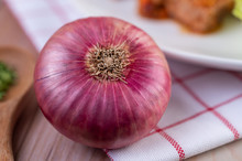 Red Onion On A Red White Handkerchief. Selective Focus.