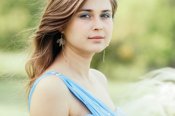 Sticker - beautiful romantic girl enjoying nature with fluffy feather grass in hands, young elegant woman face, bride in blue long dress